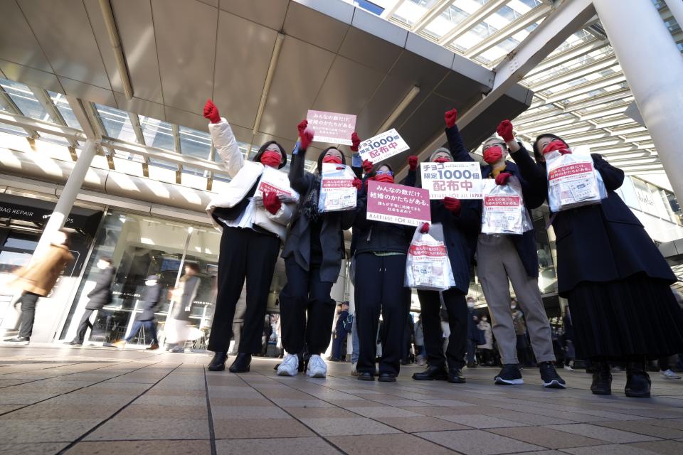 LGBTQ activists get together prior to distribute chocolates to morning commuters at Shinagawa Station, marking the fifth anniversary of the day a group of plaintiffs launched their legal battle to achieve the marriage equality, to bolster the momentum toward pushing the government to provide the protection Wednesday, Feb. 14, 2024, in Tokyo.(AP Photo/Eugene Hoshiko)