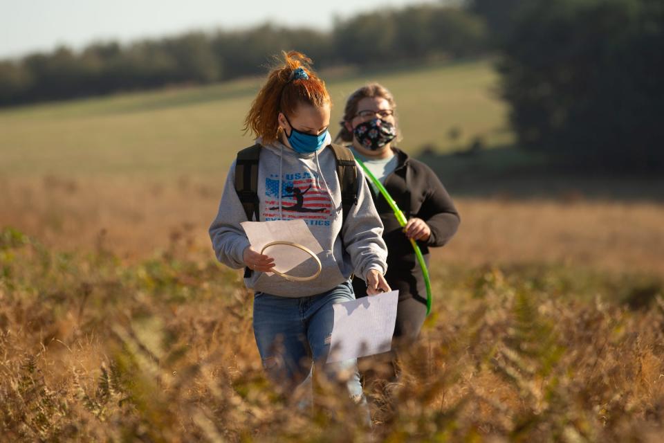 Then Chemeketa Community College environmental science students Mary Noland and Allyson Romero move through the field at Bonesteele County Park during a field lesson.