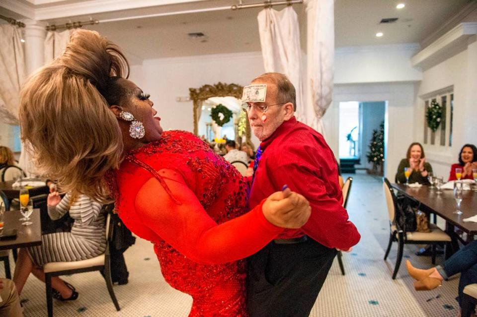 Steve Delahousey, right, a regular at the White Pillars’ drag brunch, dances with drag queen Ladi Phat Kat during drag brunch at White Pillars on Sunday, Dec. 19, 2021.