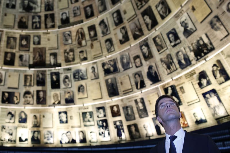 Rutte, prime minister of the Netherlands, looks at pictures of Jews killed in the Holocaust during a visit to the Hall of Names at Yad Vashem's Holocaust History Museum in Jerusalem