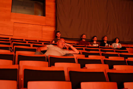 A man closes his eyes as he listens to an orchestra performing at Macedonian Philharmonics hall in central Skopje, Macedonia, June 1, 2018. REUTERS/Marko Djurica