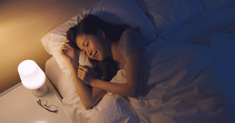 Woman sleeping well on bed at night