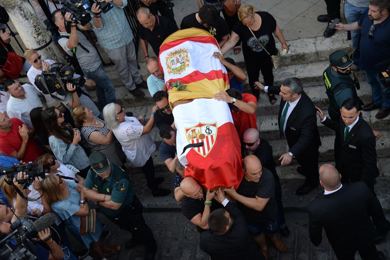 The coffin with the remains of Spanish football player Jose Antonio Reyes, covered with the flags of the village of Utrera and Sevilla FC football team, is carried on shoulders to the Santa Maria de Mesa church in Utrera, during the funeral for the footballer on June 3, 2019. - Former Arsenal, Real Madrid and Spain forward, Jose Antonio Reyes, 35, was killed in a car crash on June 1, 2019. Reyes shot to fame at Sevilla and secured a switch to Arsenal, where he was part of the unbeaten 'Invincibles' 2003-2004 Premier League winners, before spells at Real and Atletico Madrid. (Photo by CRISTINA QUICLER / AFP)        (Photo credit should read CRISTINA QUICLER/AFP/Getty Images)