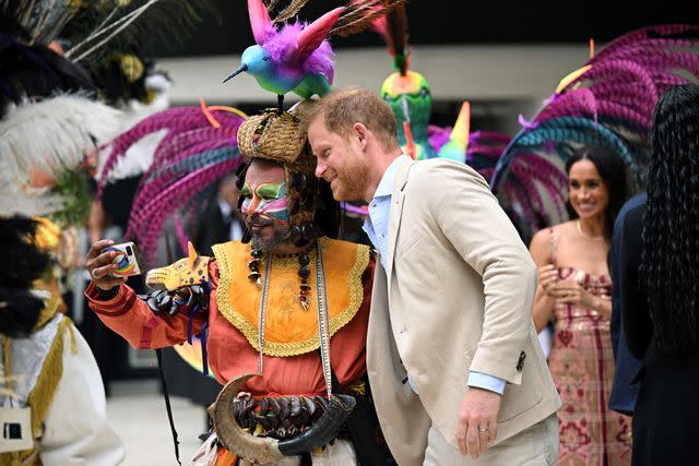 <p>RAUL ARBOLEDA/AFP via Getty </p> Prince Harry poses for a selfie in Colombia on Aug. 15, 2024