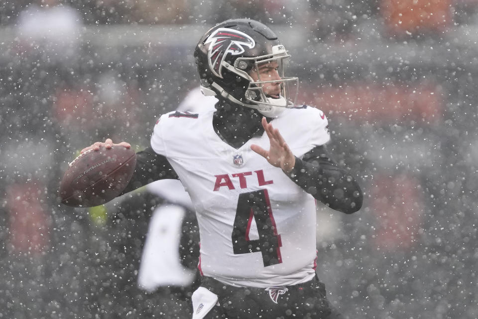 Atlanta Falcons quarterback Taylor Heinicke (4) sets back to pass in the first half of an NFL football game against the Chicago Bears in Chicago, Sunday, Dec. 31, 2023. (AP Photo/Charles Rex Arbogast)