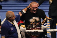 Oleksandr Usyk of Ukraine is congratulated after his unanimous decision victory over Anthony Joshua of Britain in their WBA (Super), WBO and IBF boxing title bout at the Tottenham Hotspur Stadium in London, Saturday, Sept. 25, 2021. (AP Photo/Frank Augstein)