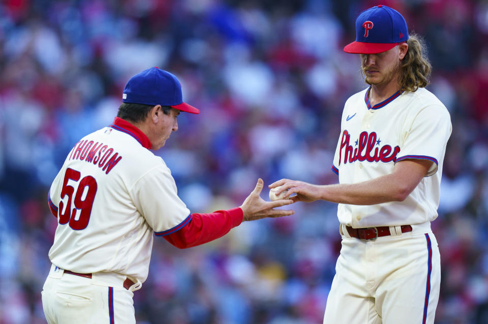 Philadelphia Phillies starting pitcher Bailey Falter, right, hands the ball off to manager Rob Thomson, left, as he is pulled during the fourth inning of a baseball game against the Atlanta Braves, Saturday, Sept. 24, 2022, in Philadelphia. (AP Photo/Chris Szagola)