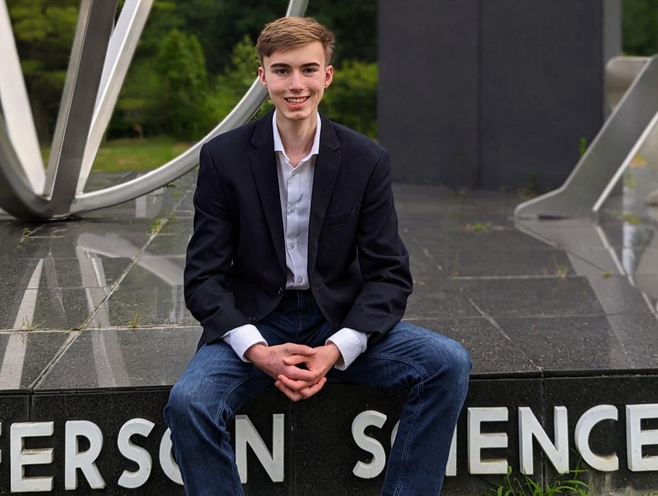 Eli Tillemann poses for a photo in front of his school, Thomas Jefferson High School for Science and Technology, in Alexandria, Virginia. | Tomicah Tillemann