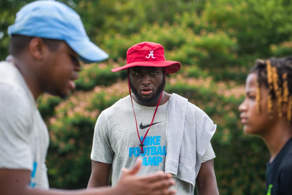 Alabama outside linebacker Will Anderson Jr. watches as a camp coach gives instructions to a young football player at the Nike Football Skills Camp at Hillcrest High School, Wednesday June 15, 2022. [Photo/Will McLelland] 