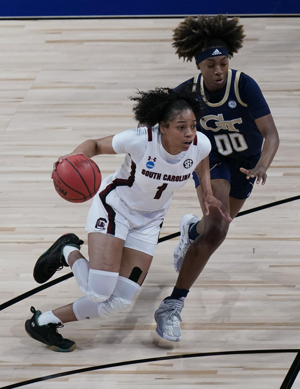 South Carolina guard Zia Cooke (1) drives around Georgia Tech guard Loyal McQueen (00) during the first half of a college basketball game in the Sweet Sixteen round of the women's NCAA tournament at the Alamodome in San Antonio, Sunday, March 28, 2021. (AP Photo/Eric Gay)