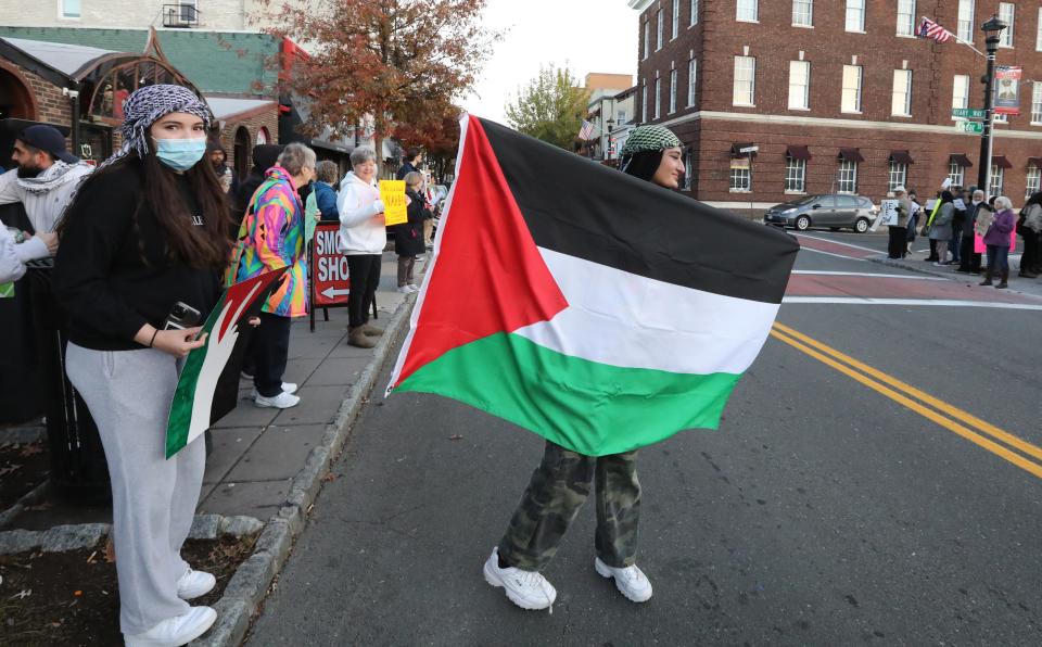 Hibba Fatima of New City holds the Palestinian flag during a protest on Main St. in Nyack, calling for a cease-fire in the Israel - Gaza conflict Nov. 10, 2023.