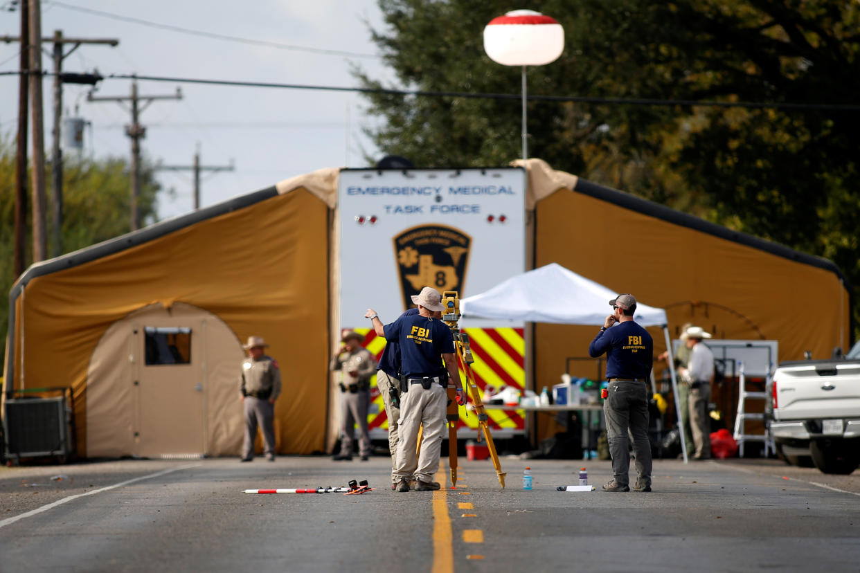 Law enforcement officers investigate the site of the shooting at the First Baptist Church in Sutherland Springs, Texas. (Photo: Jonathan Bachman/Reuters)