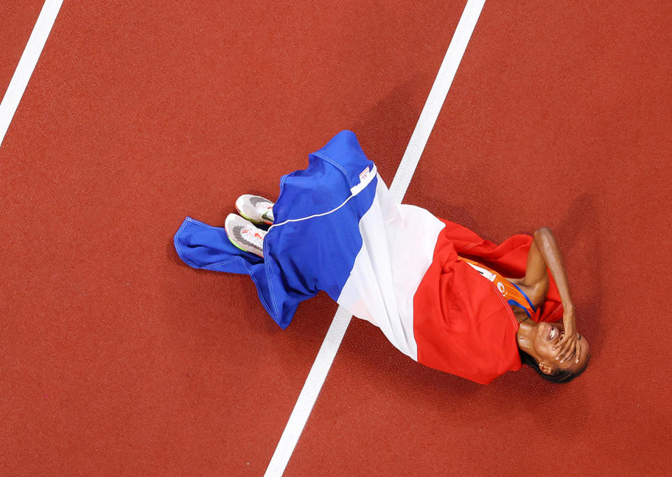 <p>Team Netherlands' Sifan Hassan lays on the track after placing first in the Women's 5000 metres Final at Olympic Stadium on August 2.</p>