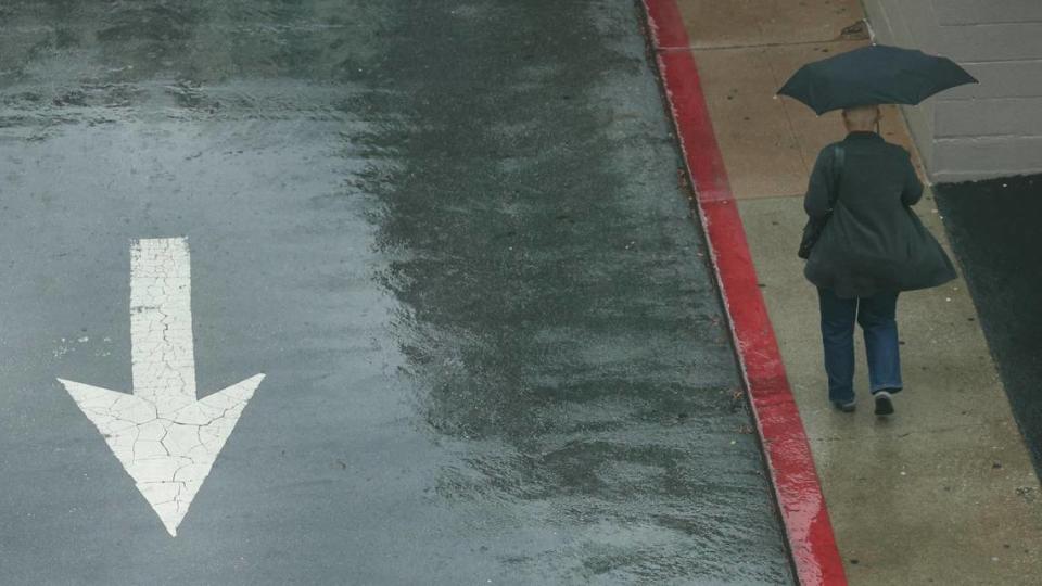 Rain falls with gusty winds in downtown San Luis Obispo, near Marsh Street on Dec. 23.