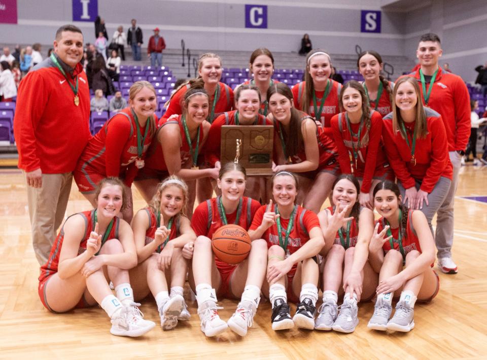 The Northwest girls basketball team celebrates after Friday's Division II regional championship win over Canfield.