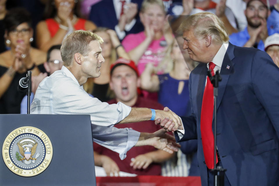 President Donald Trump, right, shakes hands with Rep. Jim Jordan, R-Ohio, left, during a rally, Saturday, Aug. 4, 2018, in Lewis Center, Ohio. (AP Photo/John Minchillo)