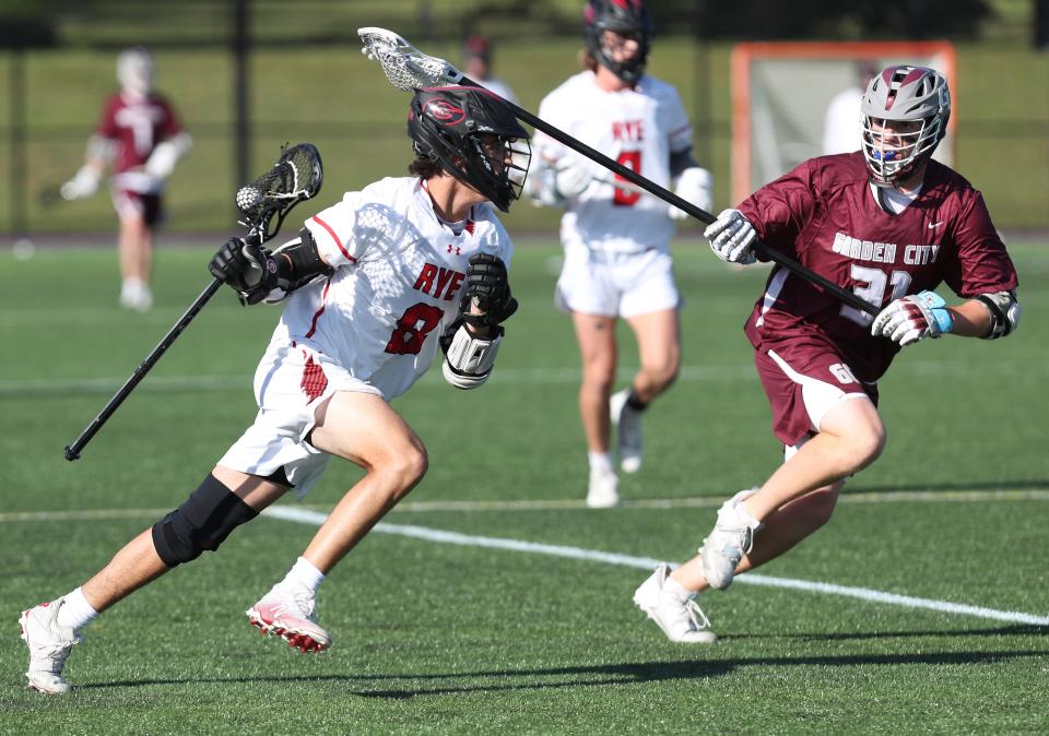 Garden City defenseman Tristan Mullahey, right, is committed to Navy for lacrosse.