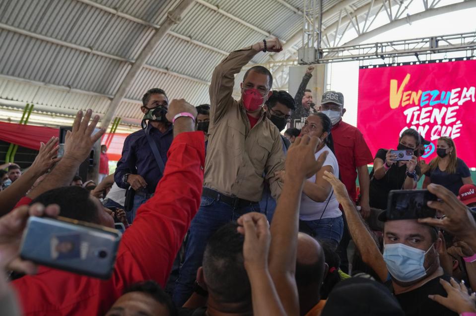 Former foreign minister Jorge Arreaza greets supporters during an event in Barinas, Venezuela, Sunday, Dec. 5, 2021. President Nicolas Maduro named Arreaza via a livestream as the ruling party's candidate for the gubernatorial race for Barinas state. The announcement came less than a week after the country's highest court disqualified opposition candidate Freddy Superlano for the governorship of Barinas as he was leading the vote count, a move that has become emblematic of what the opposition says are unfair election conditions. (AP Photo/Ariana Cubillos)