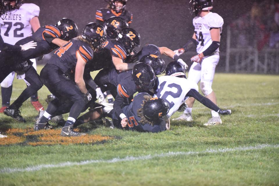 The Hudson defense swarms for a tackle during Friday's Division 8 regional final against White Pigeon.