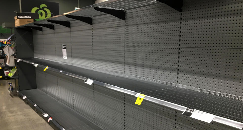 Photo shows empty shelves in a Woolworths store due to coronavirus panic buying.