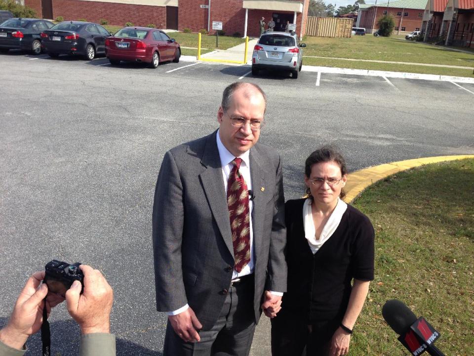 Alma and Christine Wetzker talk with reporters at Fort Stewart, Ga., after their son-in-law, Pvt. Isaac Aguigui, accused of strangling his pregnant wife 24-year-old Sgt. Deirdre Aguigui so he could pocket $500,000 in benefit money, was convicted Thursday, March 27, 2014, by a military judge in a case that hinged on dueling medical experts who couldn’t agree on how the woman died. (AP Photo/Russ Bynum)