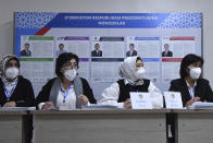 Members of an election commission wait for voters at a polling station during the presidential election in Tashkent, Uzbekistan, Sunday, Oct. 24, 2021. President Shavkat Mirziyoyev, who has relaxed many of the policies of his dictatorial predecessor but has made little effort at political reform, is expected to win a new term by a landslide against weak competition in an election Sunday. (AP Photo)