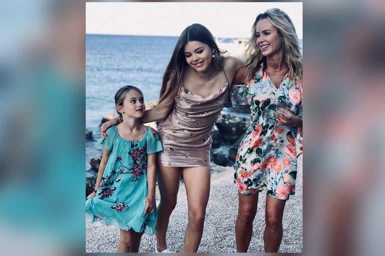 Amanda Holden was all smiles as she posed alongside her daughters on a Greek beach.The Britain’s Got Talent judge gave fans an insight into her family trip as she shared the adorable holiday snap on Instagram, captioning it: “Last night with my girlies holiday family.”The photo shows the Heart radio host grinning as she walked along the rocky sea shore in Zante alongside her two children, clutching a wine glass in her hand.Holden has her arm around oldest daughter Lexi, 13, who in turn rests her arm on the shoulder of younger sister Hollie, nine.> View this post on Instagram> > Last night with my girlies holiday family ♥️> > A post shared by Amanda Holden (@noholdenback) on Jul 17, 2019 at 10:55pm PDTThe TV star’s famous friends were quick to praise the sweet picture, with Myleene Klass writing: “All of you, so beautiful. XActress Angela Griffin added “Such a pro shot!!! You all look ace xxx” while TV chef Lisa Faulkner branded it: “Soooo gorgeous.”The star’s family holiday clashed with ITV’s annual summer party, ensuring that Holden was not present at the celebrity bash.> View this post on Instagram> > morning selfie holidays mylub ♥️☀️ rocknroll hair 🤣> > A post shared by Amanda Holden (@noholdenback) on Jul 17, 2019 at 12:59am PDTShe has shared a string of photos on Instagram since jetting off to Greece, including a rare picture of herself and record producer husband Chris Hughes.Speaking earlier this month, Holden addressed her recent decision to post images of her daughters on social media after previously keeping their faces hidden.“They’ve ended up all over my Instagram,” she told This Is Mothership’s Sofa Sessions video series.“For so long we did shots of them from the back and as they’ve grown up it’s a pride thing, you end up being so proud of them.”She went on to reveal that although her husband had initially been wary of her sharing photos of the children online, he has since changed his mind and now even encourages her to post pictures.“He said, ‘Lexi looks blinking gorgeous, you have to post that,’” she said of a recent post.