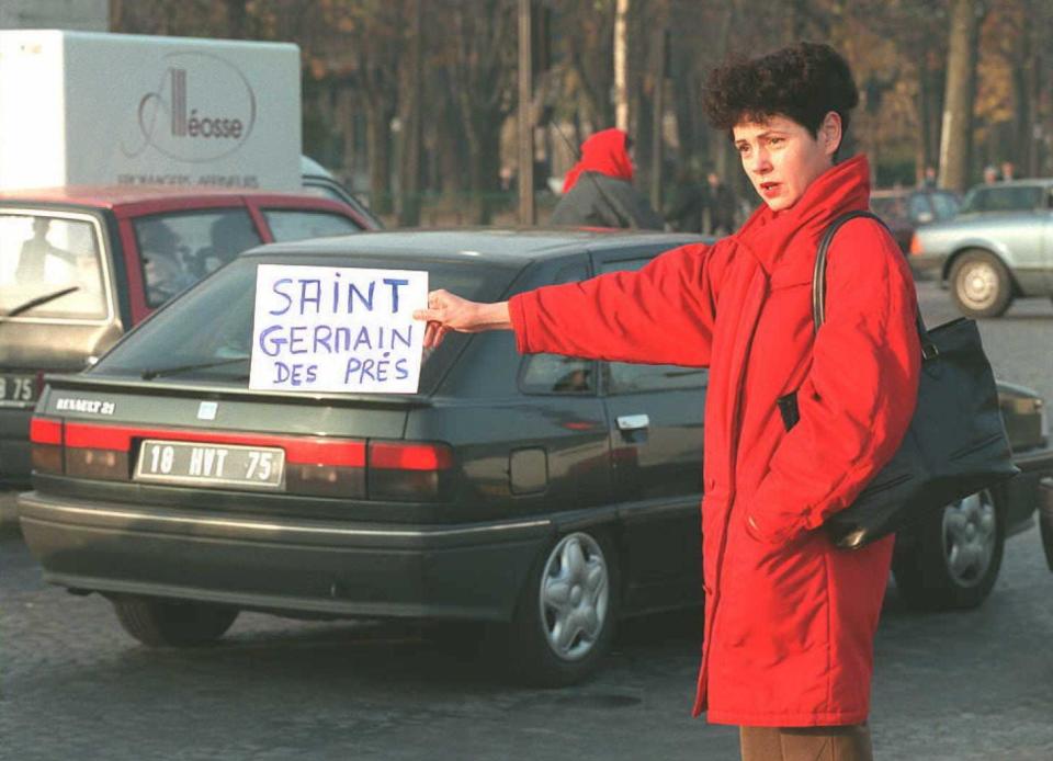 A stranded commuter tries to hitchhike to Saint-Germain-des-Pres in the Paris Latin Quarter area on the seventh day of a public transport strike which disrupts the country, 30 November.