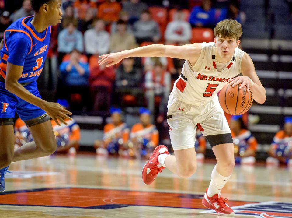 Metamora's Matthew Zobrist (5) moves the ball against East St. Louis in the second half of the Class 3A state semifinal game Friday, March 10, 2023 at State Farm Center in Champaign. The Redbirds advanced to the title game with a 50-43 win over East St. Louis.