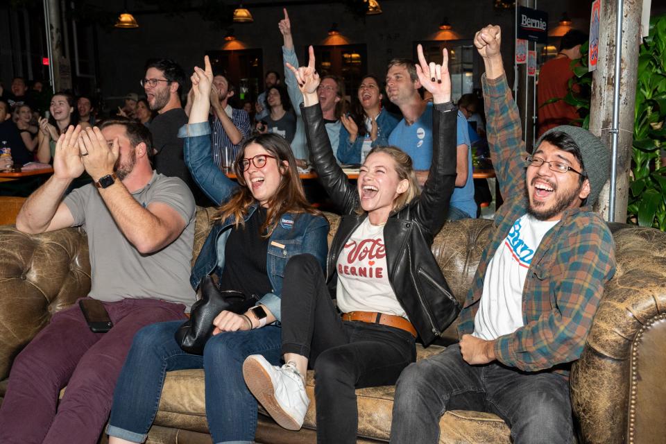 Supporters of Democratic presidential candidate Vermont Senator Bernie Sanders cheer as they hear election results during a watch party held at Central Machine Works Brewery in Austin, Texas on Super Tuesday, March 3, 2020 - Fourteen states and American Samoa are holding presidential primary elections, with over 1400 delegates at stake. Americans vote Tuesday in primaries that play a major role in who will challenge Donald Trump for the presidency, a day after key endorsements dramatically boosted Joe Biden's hopes against surging leftist Bernie Sanders. The backing of Biden by three of his ex-rivals marked an unprecedented turn in a fractured, often bitter campaign. (Photo by SUZANNE CORDEIRO / AFP) (Photo by SUZANNE CORDEIRO/AFP via Getty Images)