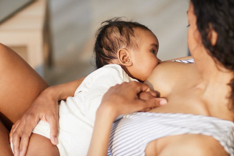 A mother breastfeeds her baby