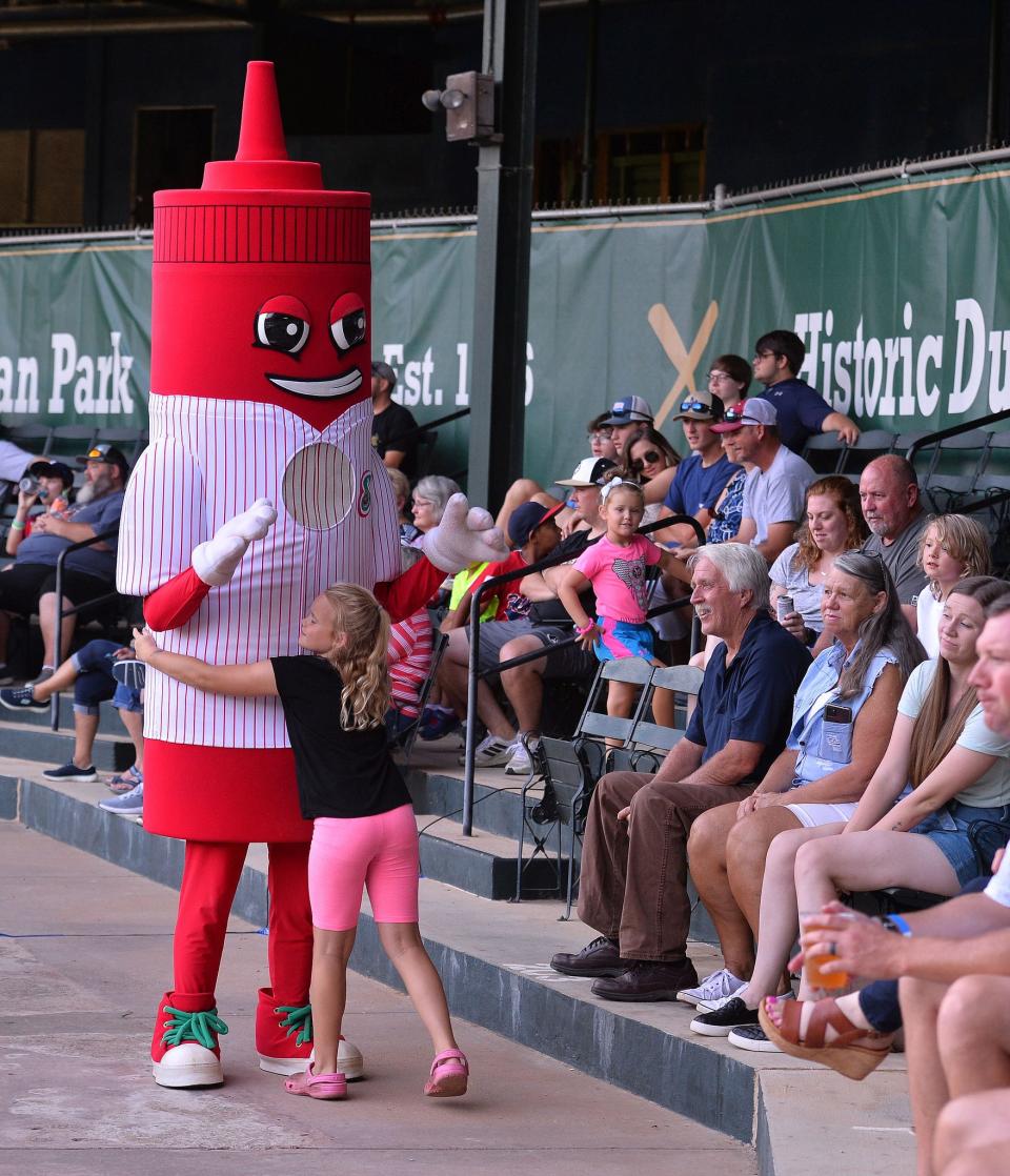 The Spartanburgers mascot, Tom 8-0, interacts with fans during Friday night's game against the Savannah Bananas at historic Duncan Park in Spartanburg.