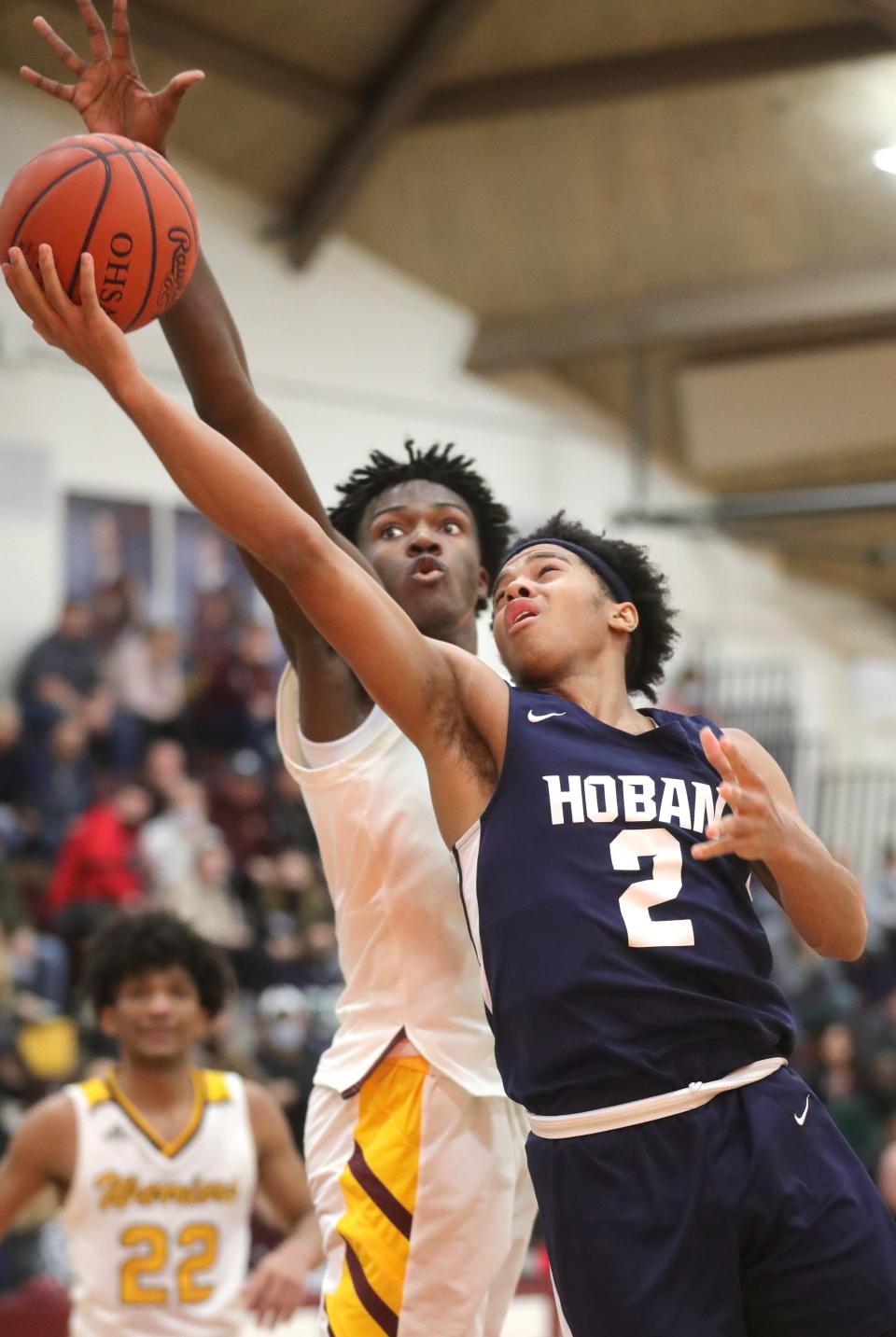 Hoban's Will Scott has his 4th quarter shot blocked by Walsh Jesuit's Keith Rivers on Tuesday, Jan. 25, 2022 in Cuyahoga Falls.