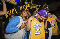 Fans celebrate, Sunday, Oct. 11, 2020, in Los Angeles, after the Los Angeles Lakers defeated the Miami Heat in Game 6 of basketball's NBA Finals to win the championship. (AP Photo/Jintak Han)