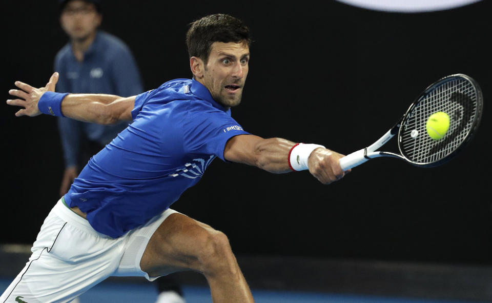 Serbia's Novak Djokovic makes a backhand return to Japan's Kei Nishikori during their quarterfinal match at the Australian Open tennis championships in Melbourne, Australia, Wednesday, Jan. 23, 2019. (AP Photo/Aaron Favila)