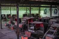 Horse carts used to give rides to tourists sit idle in the garage of a cooperative where murals of the late leader Fidel Castro and Revolutionary hero Ernesto "Che" Guevara cover the walls in Havana, Cuba, Feb. 24, 2021. "For everyone, Biden is hope," said Rigoberto Romero, owner of one of the carriages and who used to make a living by taking travelers around by horse-drawn carriage but now just takes care of his horses at home while tourism is down. (AP Photo/Ramon Espinosa)