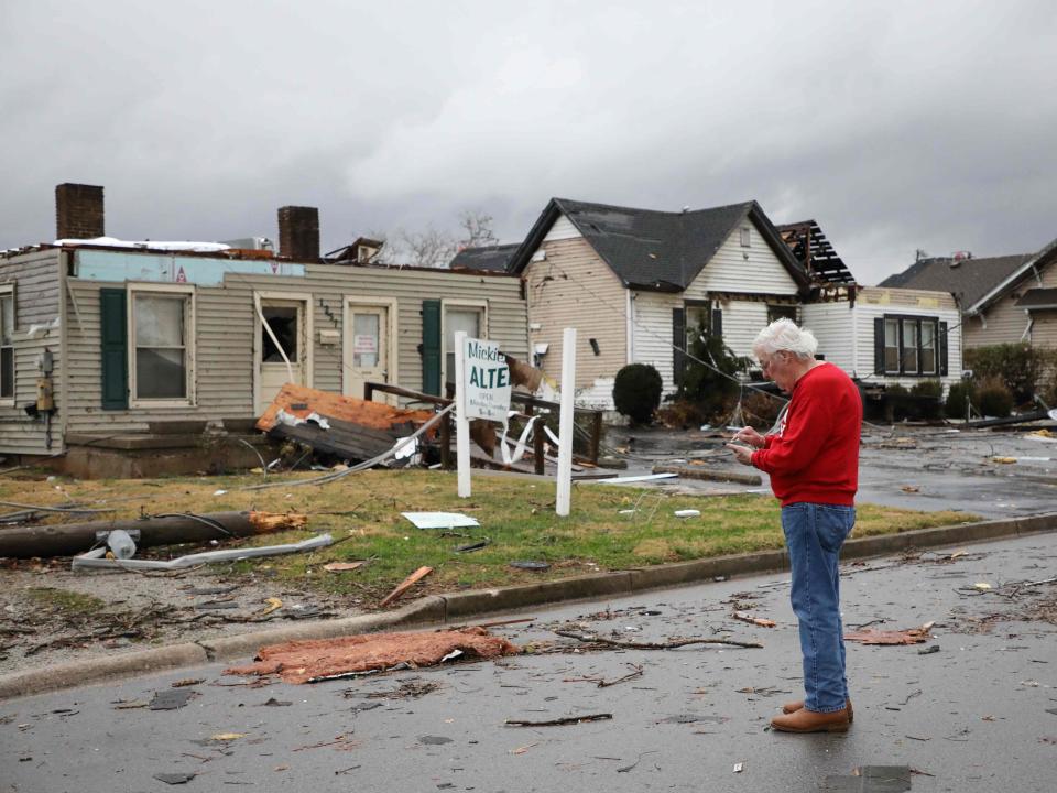 A Bowling Green, Kentucky, resident reviews the damage following a tornado that struck the area on December 11, 2021 (AFP via Getty Images)