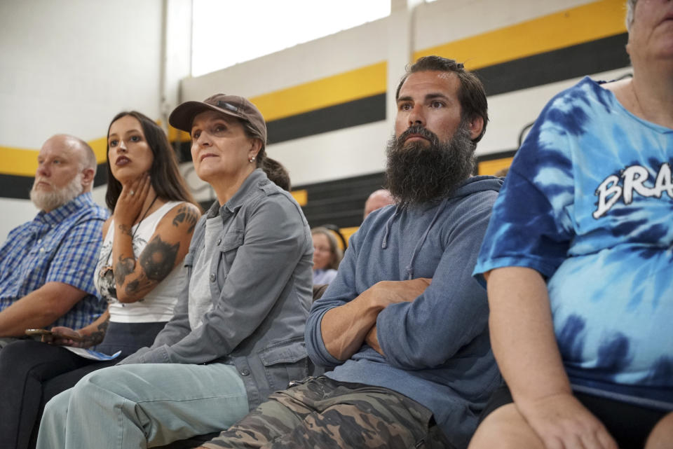 Members of the public listen to a U.S. Fish and Wildlife Service meeting about the red wolf recovery program at the Mattamuskeet School in Swanquarter, N.C., Tuesday, May 9, 2023. While agency staff talked about recent litters and captive releases, several in the crowd questioned whether the wolf should even be there. (AP Photo/Allen G. Breed)