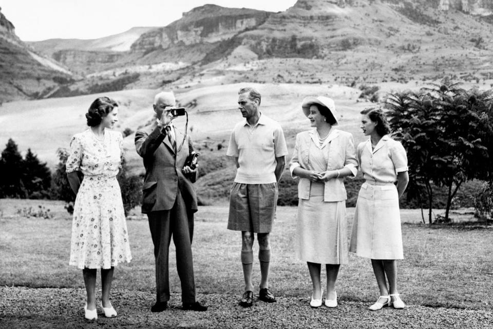 Princess Margaret, Jan Smuts, King George VI, Queen Elizabeth and Princess Elizabeth on holiday in South Africa. The Drakensberg mountain range can be seen in the background (PA Images)