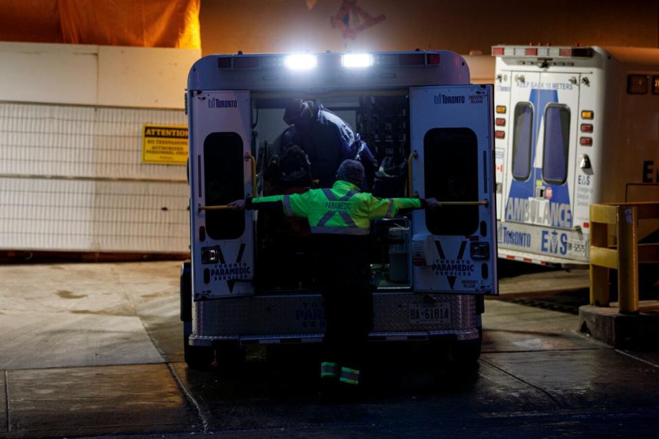 Ambulance paramedics unload a patient at the emergency department of St. Michael’s Hospital, in downtown Toronto, on Jan. 4, 2022. 