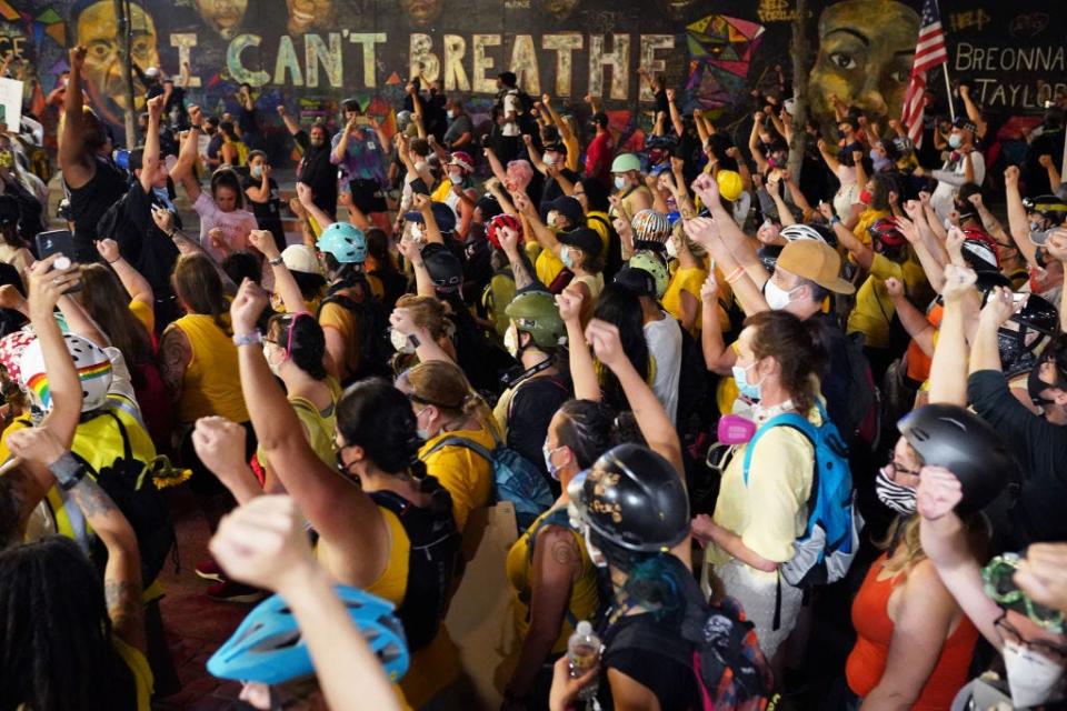 Protesters march past a mural of George Floyd's last words on their way to the Mark O. Hatfield U.S. Courthouse on July 20, 2020, in Portland, Ore. George Floyd died in Minneapolis in police custody.