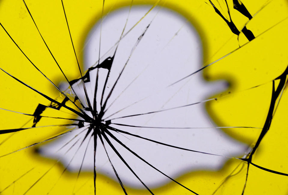 FILE PHOTO: A Snapchat logo is seen through broken glass in this illustration picture, May 11, 2017. REUTERS/Dado Ruvic/Illustration/File Photo