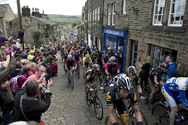 Cylists ride on a cobblestone street through the village of Haworth as they take part on the third and final day of the inaugural Tour de Yorkshire in Haworth on May 3, 2015