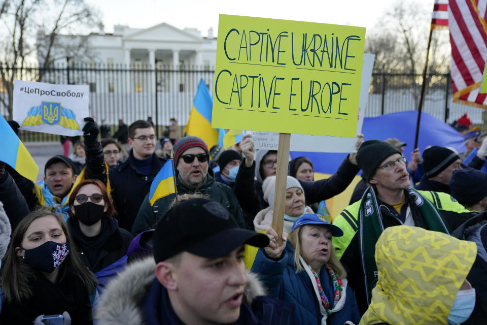 People gather following a vigil and march in solidarity with Ukraine outside the White House in Washington, Sunday, Feb. 20, 2022. (AP Photo/Patrick Semansky)