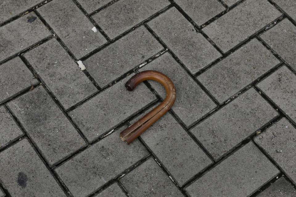 In this Friday, June 14, 2019, photo, a broken umbrella left in the aftermath of Wednesday's violent protest against proposed amendments to an extradition law is seen in Hong Kong. Umbrellas became a symbol of protest in Hong Kong in 2014 after demonstrators used them to shield themselves from both police pepper spray and a hot sun. Five years later, umbrellas were out in force again on Wednesday as thousands of protesters faced off with police outside the legislature. (AP Photo/Vincent Yu)