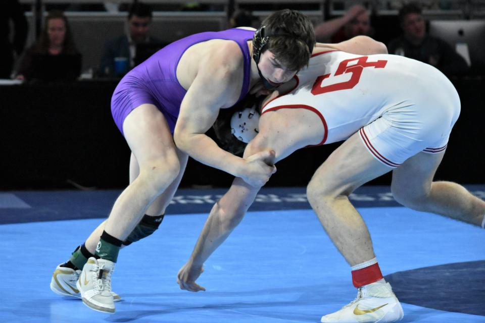 Bloomington South's Delaney Ruhlman grapples with Crown Point's Samuel Goins during their state championship match at Gainbridge Fieldhouse to end the 2021-22 season.