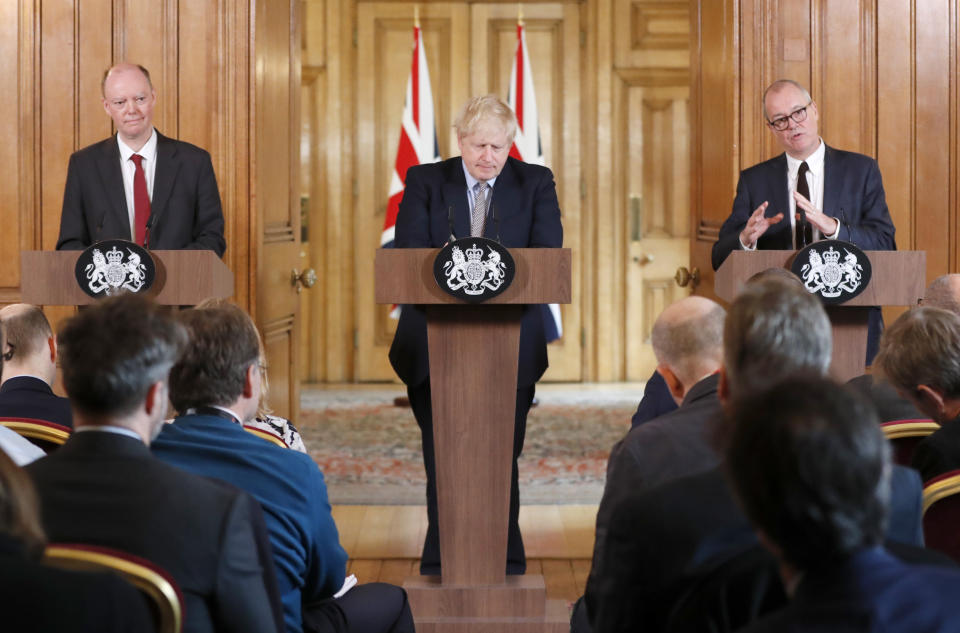 Britain's prime Minister Boris Johnson, centre, Chief Medical Officer for England Chris Whitty, left, and Chief Scientific Adviser Patrick Vallance speak as they hold a press conference at Downing Street on the government's coronavirus action plan in London, Tuesday, March 3, 2020. Johnson is announcing plans for combating the spread of the new COVID-19 coronavirus in UK.(AP Photo/Frank Augstein, Pool)