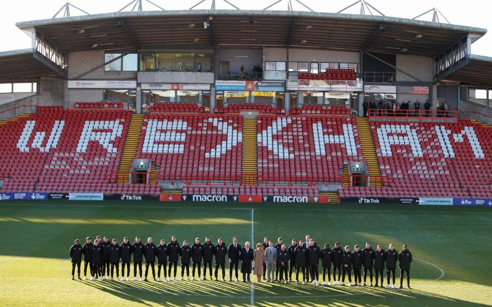 The players line up alongside their visitors on the pitch - Ed Sykes/Reuters