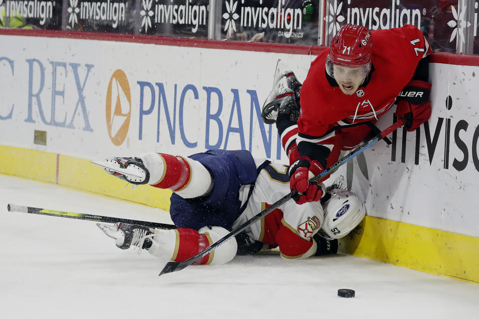 Carolina Hurricanes' Jesper Fast (71) collides with Florida Panthers' MacKenzie Weegar (52) during the second period of an NHL hockey game in Raleigh, N.C., Sunday, March 7, 2021. (AP Photo/Karl B DeBlaker)