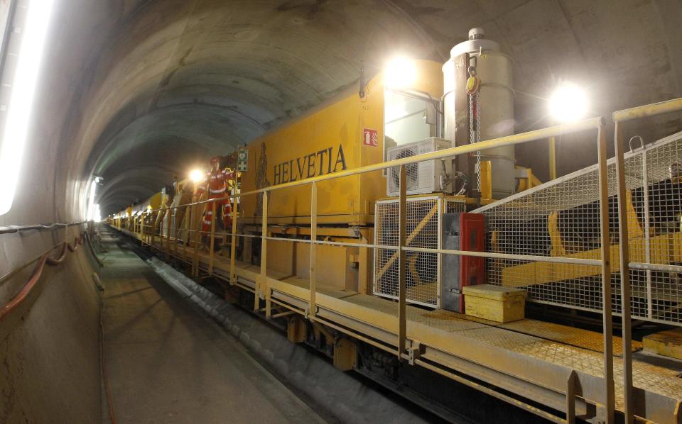 A worker stands on the special train 'Helvetia' in the NEAT Gotthard Base tunnel near Erstfeld May 7, 2012. The train, which is 481 metres (1578 ft) long and weighs 787 tons, is constructed to produce concrete for the installation of the railway tracks in the tunnel. Crossing the Alps, the world's longest train tunnel should become operational at the end of 2016. The project consists of two parallel single track tunnels, each of a length of 57 km (35 miles ) REUTERS/Arnd Wiegmann